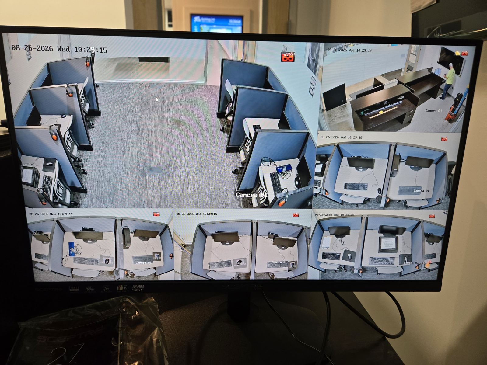 Monitor showing a multi-camera view of an office
